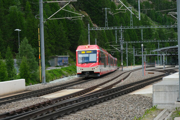 Obraz premium Selective focus and motion blur picture of train that been used to Zermatt moving at the railway. Train that lead to famous place called Matterhorn.