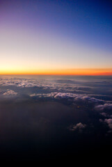 View of clouds in the sky from an airplane window