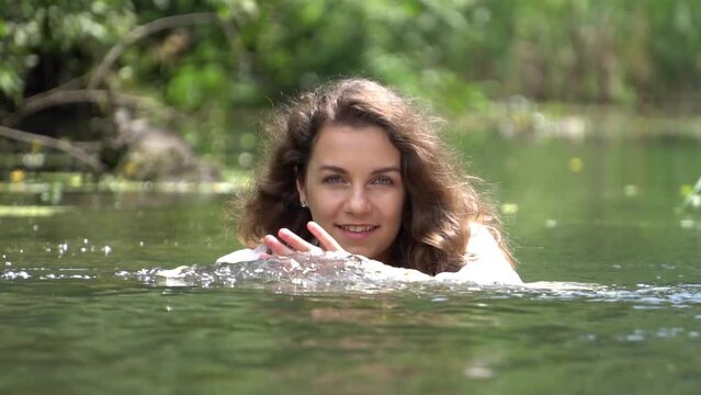 Slow Motion smiling girl on the river 