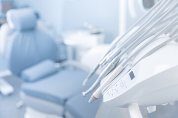 Different dental instruments and tools in dentists room office, blue toning