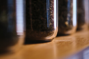 Glass containers with tea brews. Abstract background.
