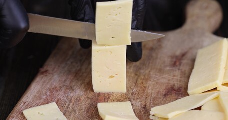 Cut yellow cheese from cow's milk, solid quality yellow cheese divided into pieces