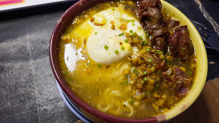 Curry-flavored instant noodles, topped with egg and fried chicken