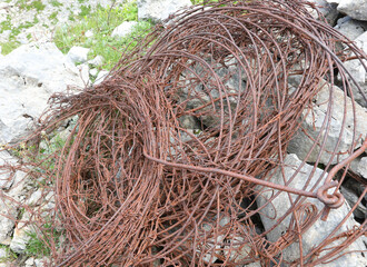 tangled skein of rusty barbed wire used to defend the borders during the first world war on the alps