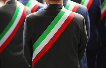 elegant Italian mayors with elegant dress during the official ceremony with the tricolor green...