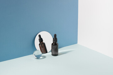 Cosmetic bottle pipette minimalist background, reflected in the mirror, background hard sunlight