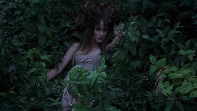 Slow Motion portrait Fantasy girl elf in green ivy fabulous garden