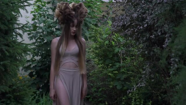 Slow Motion mystic elf in dress in forest