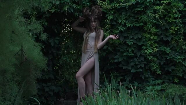 Slow Motion a girl in a light dress in an garden
