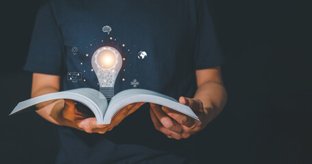 Man Reader opens a book to find new ideas with a light bulb like inventing new ideas. Ideas for...