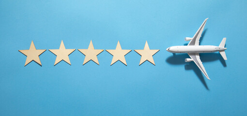 Naklejka premium Airplane with a 5 stars on the blue background.