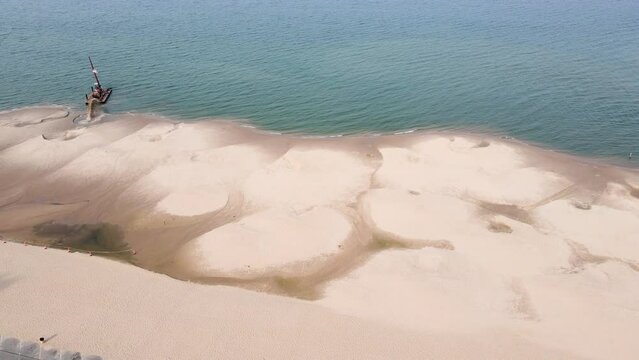 Spinning slowly around a ship dredging sand in summer.