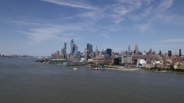 Aerial view over the river, towards the FDNY Marine 1, in sunny New York, USA