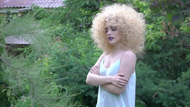 Slow Motion young fashion woman with curl blond hair
