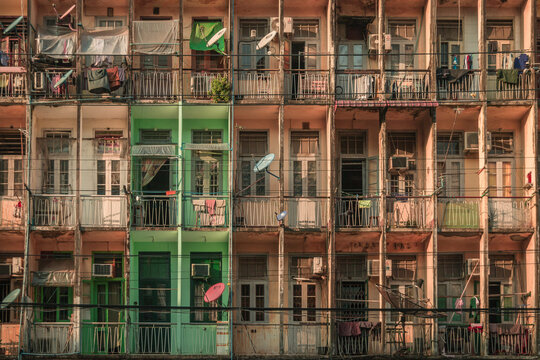 Rangoon, Myanmar - November 21st, 2019 : colorful facade of a building in Rangoon (Yangon), Myanmar around sunset.