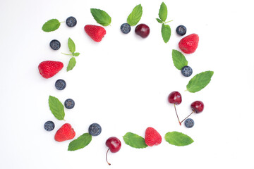 Frame of fresh mix berries with free space. Fruits frame with Blueberries, strawberries and cherry