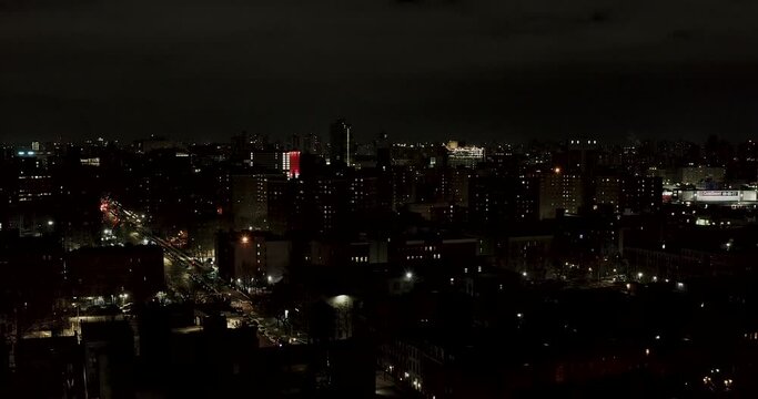 Nighttime aerial flight over the rooftops of Harlem New York City in the winter
