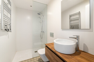 Naklejka na ściany i meble Modern minimalist bathroom with contemporary clrean interior with white sink, large mirror, toilet and shower