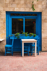 Fototapeta na wymiar Street cafe in blue tones, empty tables in Istanbul