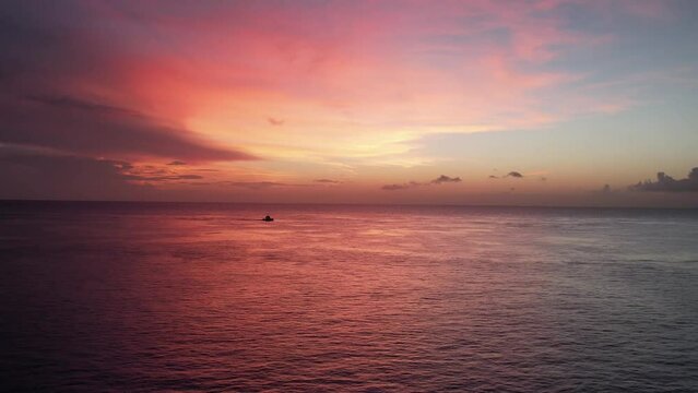 Alone boat in Mexican caribbean multicolored sunset