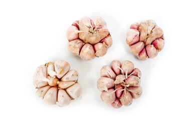 Several large heads of garlic, shot against a white background.
