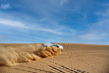 Drifting off road car 4x4 in desert. Freeze motion of exploding sand powder into the air. Action...