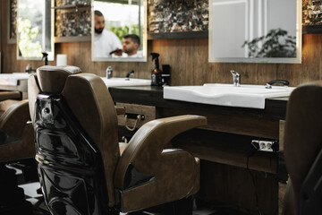 Modern empty barbershop interior with chairs and mirrors