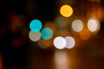 Bokeh traffic light at night in the street of a big city for background