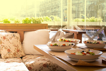 a table with healthy salads in a summer cafe