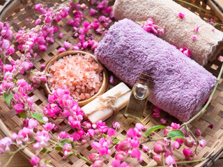 Soap with coconut massage oil essential body, Himalaya salt and towel on bamboo homemade. Aroma therapy spa set for luxury bathroom hotel or professional massage aromatic oriental for health.