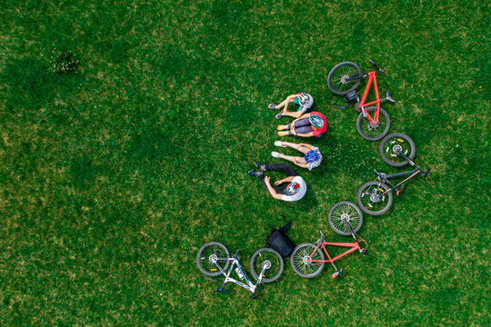 family cycling have fun on the grass. aerial view from above. Space for text