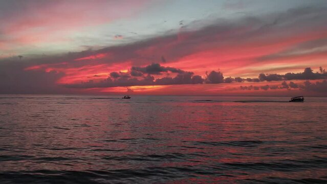 Fire sunset mexican caribbean and 3 boats on the horizon