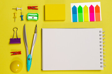 Fototapeta na wymiar Office accessories on yellow background with copy space. View from above. Back to school concept