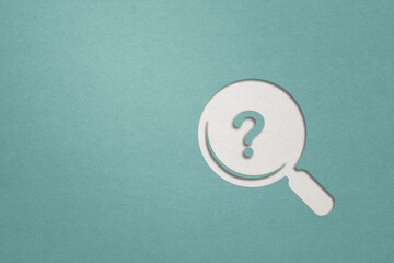 magnifying glass with question mark inside paper cut with blue background