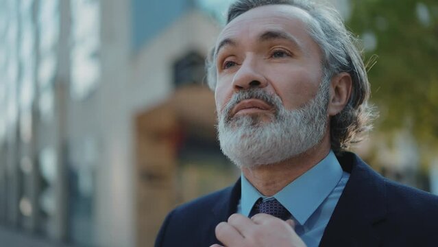 Cinematic 4k video footage of a successful senior Business man and sales person outdoor. Representation of professional expertise, financial and trading skills. Company ceo manager at work