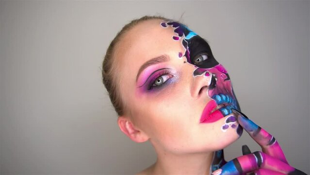 Slow Motion beautiful woman with make-up skeleton evil