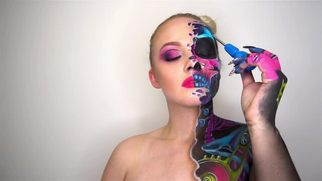 Slow Motion Beautiful scaring girl with mystical face art hold screwdriver