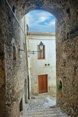 A narrow street between the old houses of Guardia Sanframondi, a village in the province of...