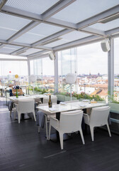 St. Petersburg, Russia, June 26, 2021, open, summer restaurant terrace without people, sunny day. Restaurant restrictions, pandemic. Light terrace furniture, modern restaurant interior