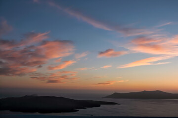 Panoramic view of the caldera, the volcano of Santorini and a beautiful colourful sky