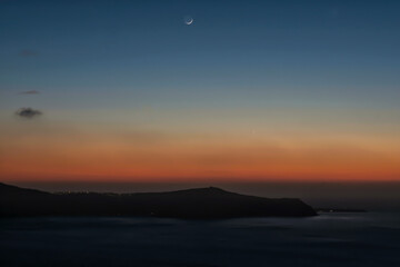Panoramic view of the caldera, the volcano of Santorini and a beautiful colourful sky
