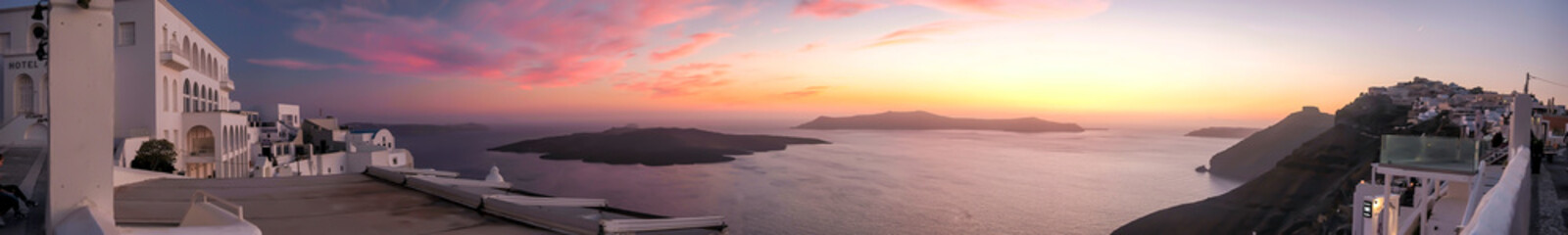 Fototapeta na wymiar Panoramic view of the caldera, the volcano of Santorini and a beautiful colourful sky