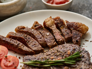 Grilled top sirloin or cup rump beef meat steak on wooden board. Dark background. Picanha steak