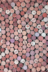 Abstract background of used red wine corks and white wine corks with corkscrew marks on corks and calendar dates on some corks