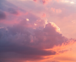 Cloudy sky during thunderstorm. Cumulus clouds shines orange and pink at the horizon during the weather changes. Weather, clouds, temperature and meteorology.