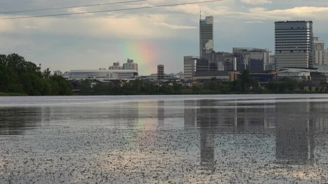 General view of the big city. Stylish modern skyscrapers are reflected in the mirror surface of a large pond.