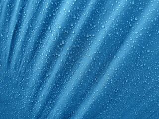 Fototapeta na wymiar Water drops on waterproof membrane fabric. Morning dew on tent.
