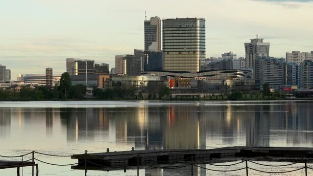 General view of the big city (Minsk), which is reflected in a large pond