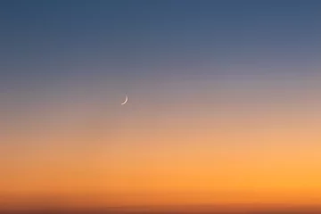 Fotobehang Sunset on clear sky with moon and the star. © Zoran Zeremski