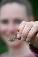 woman holding a ladybug © Evelyne Mertens